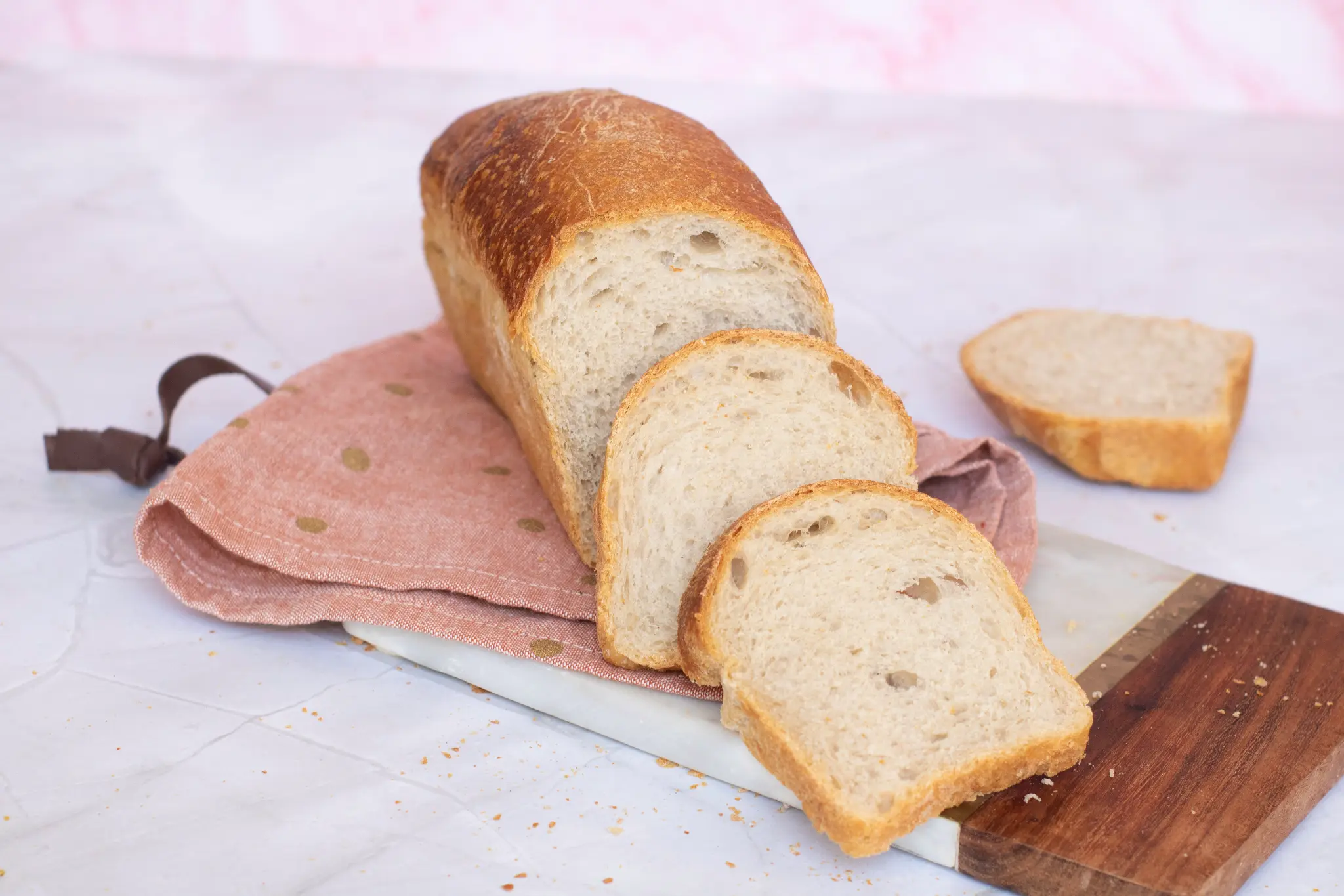 Sliced white loaf on a wooden board